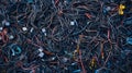 A chaotic jumble of various electrical cables and wires tangled together, representing electronic waste and cluttered technology