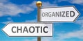 Chaotic and organized as different choices in life - pictured as words Chaotic, organized on road signs pointing at opposite ways