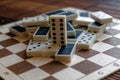 Chaotic pile of domino pieces on the bamboo brown wooden table background