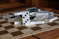 Chaotic pile of domino pieces on the bamboo brown wooden table background Royalty Free Stock Photo