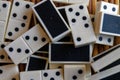 Chaotic pile of domino pieces on the bamboo brown wooden table background Royalty Free Stock Photo