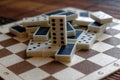 Chaotic pile of domino pieces on the bamboo brown wooden table background Royalty Free Stock Photo