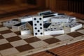 Chaotic pile of domino pieces on the bamboo brown wooden table background Royalty Free Stock Photo