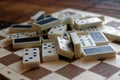 Chaotic pile of domino pieces on the bamboo brown wooden table background