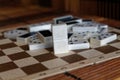 Chaotic pile of domino pieces on the bamboo brown wooden table background Royalty Free Stock Photo