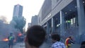 Chaotic riot scene with fire and tear gas bombs