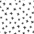 Chaotically scattered black crosses drawn by hand with a rough brush. Isolated on white background. Modern seamless pattern. Royalty Free Stock Photo