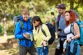 Chap and lassie from hiking group study map Royalty Free Stock Photo