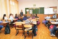 Schoolkids in the classroom sitting at their desks and listen to the teacher