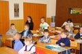 Schoolkids in the classroom sitting at their desks and listen to the teacher