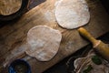 Chapati bread preparation on the wooden board top view