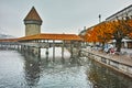 Chapel Bridge over Reuss River and autumn tree in Lucerne, Switzerland