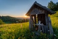 Chapel with cross sunset over green meadows and mountains with meadow and tree in the middle of Romania Royalty Free Stock Photo