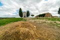 A chapel with cypresses in the center of the field. Church on a hill and green surroundings. Chapel of the Madonna di Royalty Free Stock Photo