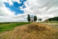 A chapel with cypresses in the center of the field. Church on a hill and green surroundings. Chapel of the Madonna di Royalty Free Stock Photo