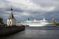 Chapel ` Savior-on-the-Water ` and the `Albatross` cruise liner on gloomy Neva river. Saint-Petersburg