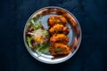 Chapli kabab served with fresh salad, a classic Indian dish