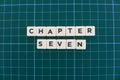 Chapter seven word made of square letter word on green square mat background