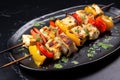 char-grilled fish skewers on black ceramic plate Royalty Free Stock Photo