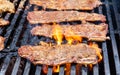 Char-grilled Marinated BBQ Korean Short Ribs on a barbecue grill with open flames