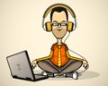 User in orange shirt and headphones with a laptop Royalty Free Stock Photo