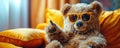 character plush teddy bear in sunglasses points with finger sitting in room on couch