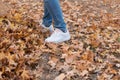 The character`s feet are stepped on fallen leaves on the ground Royalty Free Stock Photo