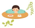 The character is sitting with his head in his hands. A child is drinking tea with a cupcake Royalty Free Stock Photo