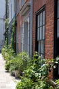 Characterful historic houses with flower pots on the pavement, on Wilkes Street in Spitalfields, East London.