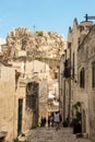 Characteristic alley with tourists and in the background the Sasso Caveoso