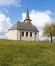 Characteristic church in the green field in the Swiss Alps of the Canton Jura