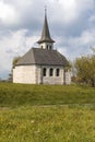 Characteristic church in the green field in the Swiss Alps of the Canton Jura