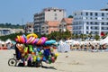 Toys seller cart with plastic toys and beach balls on the sandy beach