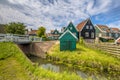 Characteristic Dutch village scene with wooden houses and bridge