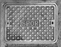 Characteristic iron manhole cover in the streets of the city of Rome Royalty Free Stock Photo