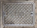 Characteristic iron manhole cover in the streets of the city of Rome Royalty Free Stock Photo