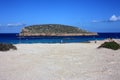 Characteristic islet of conillera bosc espartar in cala comte in ibiza in summer in front of the cliff Royalty Free Stock Photo