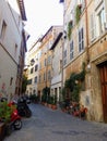 Characteristic narrow street in the historical center of Rome in Italy. Royalty Free Stock Photo