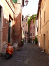 Characteristic narrow street in the Trastevere district to Rome in Italy. Royalty Free Stock Photo