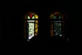 Characteristic windows with colorful stained glass as a light source - an image from the inside of a Christian church. Royalty Free Stock Photo