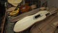 Charango and red wood guitar on a pile of unassembled guitar parts