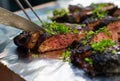 Charbroiled steak being cut over foil table Royalty Free Stock Photo