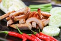 Charcoal-boiled Pork Neck on black plate thai food