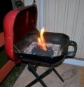 Barbecue Grill With Flaming Charcoal Briquettes Royalty Free Stock Photo