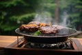 charcoal grill with sizzling steak and smoke