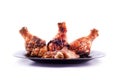Charcoal grilled chicken legs on a black plate,isolated Royalty Free Stock Photo