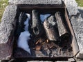 Charcoal and snow in the outdoor fire place for barbecue Royalty Free Stock Photo