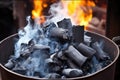 charcoals burning with smoke in a cylindrical chimney starter Royalty Free Stock Photo
