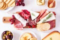 Charcuterie board top view table scene on a white marble background Royalty Free Stock Photo