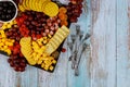 Charcuterie board with cheese, grape, raspberry and crackers